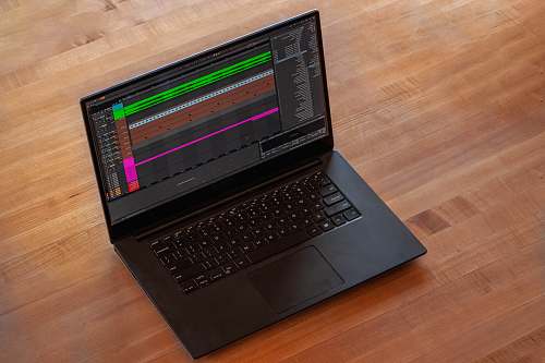 computer black laptop computer on brown wooden table computer hardware